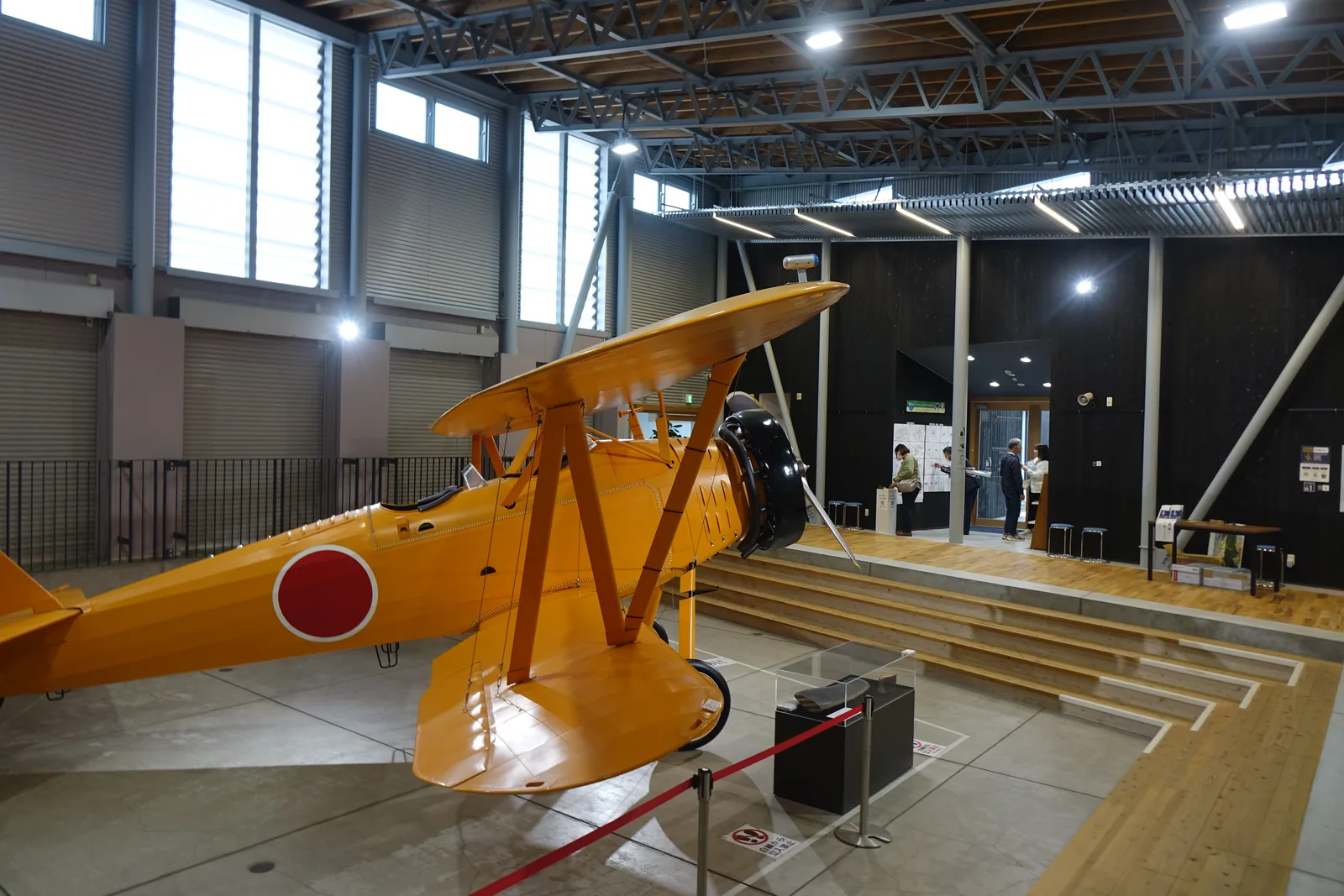 資料館展示廳裡的九三式中間練習機實物大模型，機身橘色，翼上有日之丸